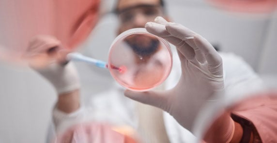 scientist-with-petri-dish-in-pharmaceutical-facility